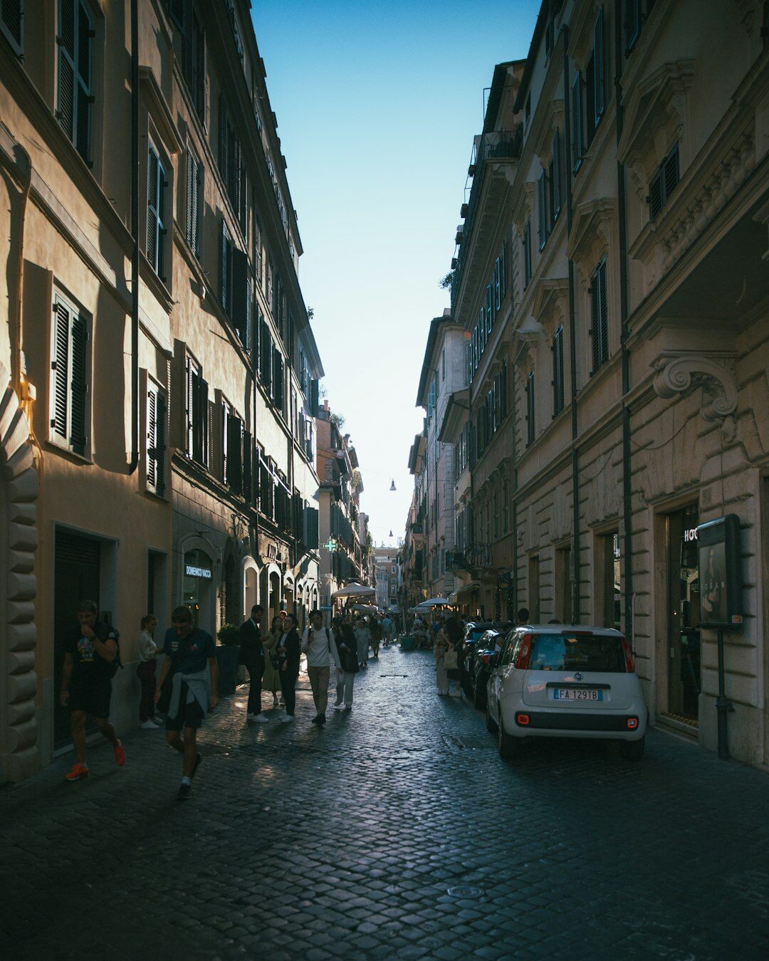 European sedan parked on a cobblestone street in a European city