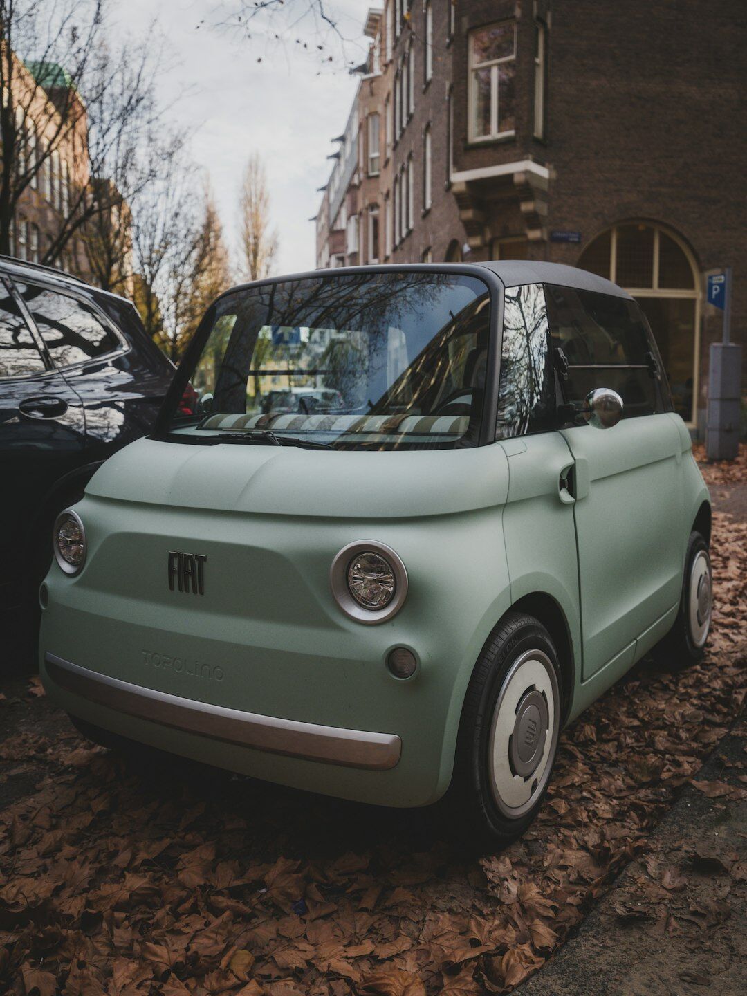 Compact electric city car parked on an urban street
