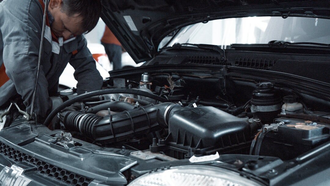 mechanic checking car engine