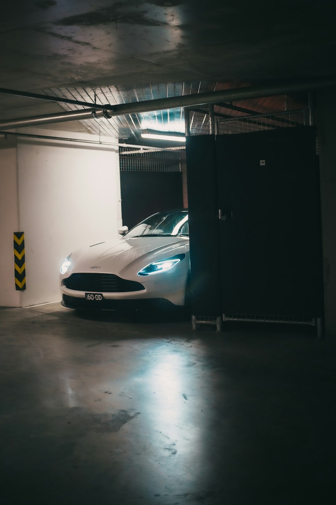 Yellow sports car parked in a dark underground garage